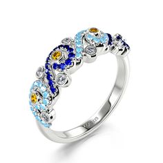 a white gold ring with blue, yellow and white stones in the center on a white background