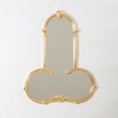 a mirror that is on the wall with a heart shaped frame in front of it