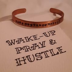 a bracelet that says wake - up pray and hustle on top of a piece of paper