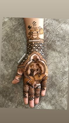 the hand is decorated with henna and designs on it, as well as an image of