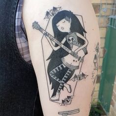 a woman with a guitar tattoo on her arm