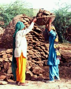 two women carrying baskets over their heads