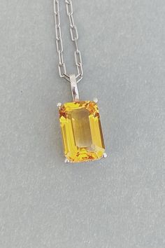 This Citrne Necklace is made from Natural Citrine and S925 Silver. Its vibrant yellow color and classic design make it the perfect gift for any special occasion. Item Detail: - Gemstone: Natural Citrine. - Stone size: 8x12mm - Cut type: Emerald. - Colour: Yellow - Material: S925 Silver #citrine #gemstone #necklace #pendant #quartz Classic Orange Jewelry As Gift, Classic Orange Jewelry For Gift, Classic Orange Necklace For Gift, Classic Orange Necklace For Gifts, Minimalist Yellow Sterling Silver Jewelry, Formal Yellow Hallmarked Necklace, Classic Yellow Citrine Jewelry, Classic Yellow Pendant Necklace, Formal Yellow Pendant Necklace