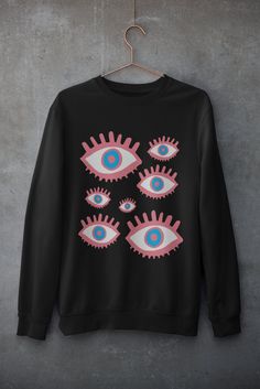 Pastel Goth Eyes Sweatshirt Choose one or two sizes up for an oversized look Usually dispatched in 5 working days ECO-FRIENDLY Each garment is made to order, reducing extra material and energy that would be otherwise wasted We use DTG printing process which is easier on the environment than screen-printing Our ink is bright and also eco-friendly. Material: 80% ringspun cotton/20% polyester. - Drop shoulder style. - Stylish fit. - Soft cotton faced fabric. - Taped neck. - Ribbed collar, cuffs and Y2k Graphic Print Halloween Sweatshirt, Y2k Halloween Graphic Print Sweatshirt, Y2k Graphic Print Sweatshirt For Halloween, Y2k Graphic Print Long Sleeve Sweatshirt, Y2k Long Sleeve Graphic Print Sweatshirt, Oversized Grunge Graphic Sweater, Oversized Grunge Sweater With Graphic Print, Oversized Y2k Crew Neck Sweatshirt, Black Oversized Alternative Sweatshirt