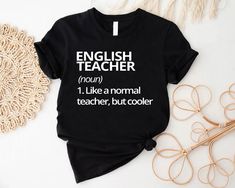 "Funny English Teacher Tshirt, English Teacher Gift, English Teacher Definition Tee, Teacher Appreciation,Back to School Tee,Gift For Teacher, Teacher Team Shirts, Teachers Day Gift, Teacher Life Shirt, New Teacher Gift, Teacher Birthday, Teacher Quote ----- How To Order ----- 1-) Please, check and review all the photos. 2-) Choose your t-shirt size and color. *Different styles of shirts may have different shades of same color choice due to different manufacturer brands. *For this reason, we recommend you to match shirts from the same styles if you want precisely matching colors (ex. Unisex, V-necks, Toddler, etc.). 3-) Click add to cart. You can go back to add more shirts. 4-)Click \"Proceed to check out\". 5-)When you check out, you can add a note to seller for any request. ----- Unisex English Teacher Tshirts Funny, Black Top With Text Print For Teaching, Black Text Print Top For Teaching, Black Shirt With Text Print For Teacher Appreciation, Graphic Tee With Text Print For Teaching, Cotton T-shirt With Name Print For Teaching, Teacher T-shirts, Teacher Tshirt Ideas, English Teacher Shirts