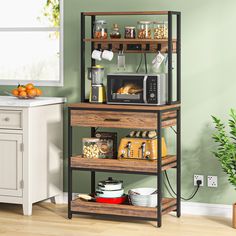 a microwave, toaster oven and other kitchen items in a room with green walls