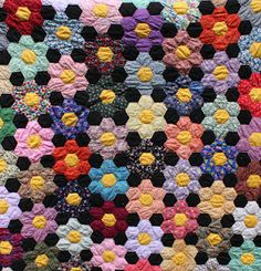 a multicolored crocheted blanket is shown