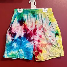 Loose fitting athletic shorts tie-dyed in a myriad of colors and designs.  The shorts are 100% cotton, contain side pockets, and have an elastic waistband.  The colors are washfast, though to retain the brightness they are best washing in cold and dried hot in the dryer.  The shorts come in men's small and medium. Multicolor Cotton Pajama Shorts With Relaxed Fit, Multicolor Cotton Swim Trunks For Summer, Cotton Athletic Shorts With Elastic Waistband For Beach Season, Casual Multicolor Swim Trunks With Elastic Waistband, Multicolor Summer Shorts With Elastic Waistband, Multicolor Cotton Swim Trunks For Beach Season, Multicolor Cotton Swim Trunks For Beach, Multicolor Athletic Shorts With Built-in Shorts For Spring, Tie Dye Cotton Bottoms With Elastic Waistband