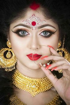 a woman with makeup and jewelry on her face