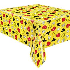 a yellow table cloth with mickey mouse faces on it