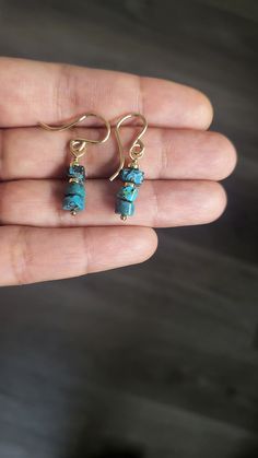 These exquisite earrings are crafted from top-quality, natural turquoise with an organic cut and finish, measuring approximately 6 mm in width. Despite their petite size, their vibrant color and accent beads make them stand out and capture attention. These earrings can be customized in sterling silver, gold-filled, or rose gold-filled finishes. With an approximate length of 1 inch, they are ideal for those who appreciate minimalistic jewelry Rustic Turquoise Earrings For Gift, Rustic Drop Earrings Jewelry For Gift, Rustic Drop Earrings Jewelry Gift, Rustic Drop Earrings As A Gift, Rustic Wire Wrapped Earrings For Gift, Rustic Gemstone Jewelry For Gifts, Dainty Turquoise Earrings For Gift, Dainty Turquoise Earrings As Gift, Rustic Dangle Earrings As A Gift