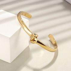 Our Sydney Bangle features a unique knot design that makes it a stand-out piece. This piece is incredibly versatile and can be worn every day. Details: Stainless Steel 18k Gold Plated