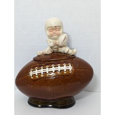 a football with a baby sitting on it