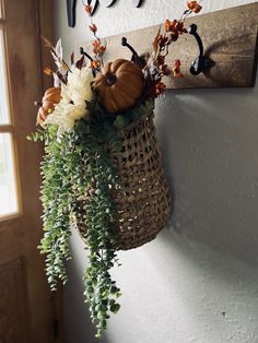 a basket filled with flowers hanging from a wall