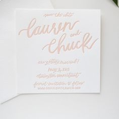 the wedding stationery is set on top of a white envelope with gold foil lettering