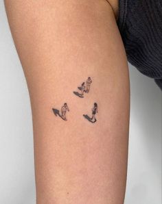 a woman's thigh with small tattoos on it