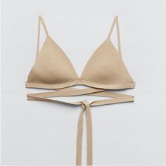 50% Viscose 50% Nylon Chic Triangle Top Bra With Straps, Summer Triangle Top With Seamless Construction, Beige Fitted Triangle Top, Chic Fitted Triangle Top Bra, Beige Fitted Bra For Beach, Fitted Beige Bra For Beach, Fitted Bra With Delicate Straps For Spring, Summer Stretch Bra With Delicate Straps, Seamless Beige Bra For Spring