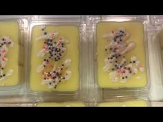 six candles with sprinkles in plastic containers