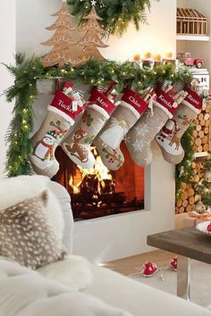 christmas stockings hung over a fireplace in a living room