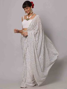 Wear this designer saree with amazing trending sequin work to create fashion statements. This sequin saree can be adorned at parties and receptions. With its beautiful white georgette material and heavy sequin work, this saree is bound to turn heads wherever you go.
The saree features a stunning sequin floral borderwork, adding an elegant touch to the overall design. The heavy sequin work on both the saree and blouse enhances its beauty and makes it a perfect choice for special occasions.
Measur White Bollywood Pre-draped Saree For Reception, Silver Georgette Pre-draped Saree For Wedding, White Lehenga With Traditional Drape For Evening, Designer Wear Pre-draped Georgette Saree With Sequins, White Georgette Pre-draped Saree For Reception, White Traditional Drape Blouse Piece For Evening, Festive White Pre-draped Saree With Unstitched Blouse, Celebration White Pre-draped Saree With Dupatta, Glamorous Sequined Pre-draped Saree For Festivals