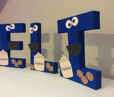 the letters are made out of cardboard and have eyes, nose, and cookies on them