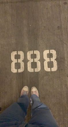 a person standing in front of the number eighty three on an asphalt area with white numbers