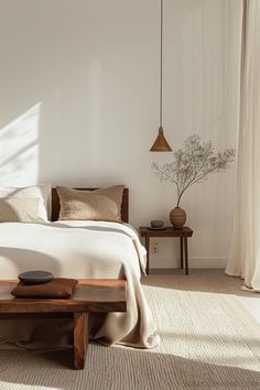 Minimalist bedroom decor with aesthetic and neutral style, wood bed, walnut wood side table, and white bedding Bedrooms Aesthetic Minimalist, Primary Bedroom Ideas Minimal, Minimalist Bedroom Studio, Aesthetic Home Minimalist, Minimal Boho Aesthetic, Warm And Minimalist Bedroom, White Minimalism Aesthetic, Minimalist Main Bedroom, Cozy Minimalist Home Aesthetic