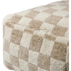 a brown and white checkered blanket on top of a bed