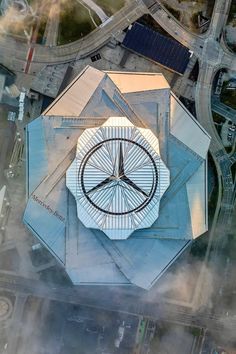 an aerial view of a building with a clock on it's face in the center