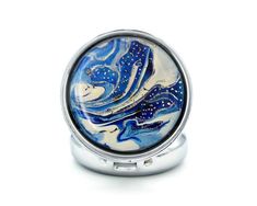 a ring with blue and white swirls on the inside, sitting in front of a white background