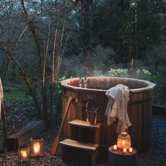 an outdoor hot tub surrounded by candles