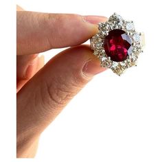 A large and fine ruby, weighing an impressive 5.03 carats, takes center stage of this platinum ring. The ruby has many characteristics which makes it fine and rare. The color is intense red while the crystal of the stone is bright and clean allowing for excellent light return. It is also certified by the GIA as natural coming from a unique origin of Madagascar, the island of gems. The ruby is complemented by a halo of large and bright round brilliant-cut diamonds weighing a total of 5.17 carats! Timeless Polished Ruby Ring, Luxury Red Ruby Ring With Vvs Clarity, Vvs Clarity Ruby Ring For Formal Occasions, Ruby Ring With Vvs Clarity For Formal Occasions, Formal Red Ruby Ring In Platinum, Formal Red Diamond Platinum Ring, Luxury Ruby Gemstone Ring In Platinum, Luxury Red Platinum Rings, Red Ruby Ring With Halo Setting In Platinum