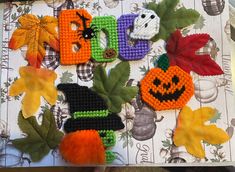 the letters are made out of beads and decorated with pumpkins