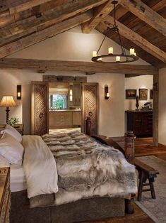 a large bed sitting under a wooden ceiling