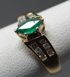 7 x 3.75mm marquis Emerald in great color. 12 Diamonds in an off set shoulder design. A really elegant ring showing light wear. 1.66 dwt. Update: Per customer request, Had Karin take a look at the stone. Excellent stone with a tiny chip on the girdle. Through a 10X loupe to find it. Adjusting price accordingly Classic Emerald Ring Marquise Cut, Classic Marquise Emerald Ring, Classic Marquise Cut Emerald Ring, Classic Formal Marquise Emerald Ring, Classic Formal Emerald Marquise Ring, Marquise Emerald Ring For Formal Occasions, Classic Marquise Cut Emerald Ring For Anniversary, Classic Marquise Cut Emerald Ring For Formal Occasions, Marquise Emerald Ring With Center Stone