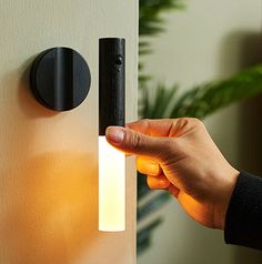 a person is opening the door with their finger and pressing it on to the light