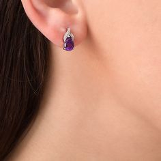 Appeal to her sophisticated taste with these exciting gemstone drop earrings. Created in sterling silver, each graceful earring showcases a 7.0 x 5.0mm pear-shaped bright purple amethyst beneath a flame-inspired design of overlapping ribbons adorned with sparkling diamond accents and beaded detailing. Buffed to a brilliant luster, these post earrings secure comfortably with friction backs. Fine Jewelry Teardrop Earrings For Formal Occasions, Elegant Teardrop Gemstone Earrings, Elegant Amethyst Earrings For Formal Occasions, Elegant Oval Teardrop Earrings For Formal Occasions, Elegant Gemstone Teardrop Earrings For Anniversary, Elegant Gemstone Drop Earrings, Fine Jewelry Teardrop Pendant Earrings As Gift, Formal Teardrop Gemstone Earrings, Fine Jewelry Teardrop Earrings For Gift