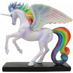 a white unicorn with rainbow mane and wings