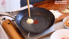 a frying pan with some food in it on top of a stove burner