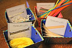 three boxes filled with different types of yarn and paper straws on top of a wooden table