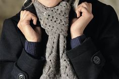 the woman is wearing a scarf around her neck