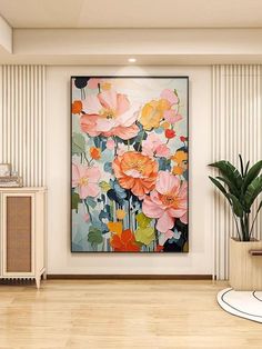 a large painting hanging on the wall in a living room next to a potted plant