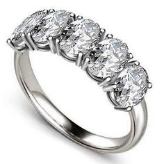 a five stone ring with four diamonds on it