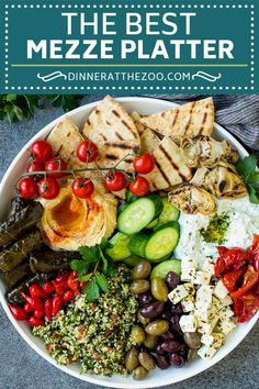 the best mezze platter with olives, tomatoes, cucumbers and pita bread