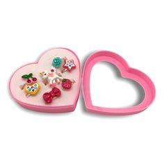 Get glam with this set of 7 pretty, sparkly, adjustable rings by Ppoppo. Perfect for dress up fun! Packed in a pretty heart-shaped gift box. Ring styles vary slightly.