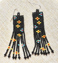 two pairs of black beaded earrings with multicolored beads and fringes on them