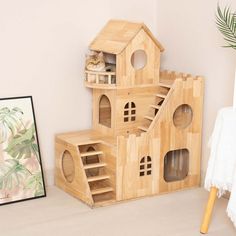 three wooden bird houses sitting on top of a white floor next to a framed photograph