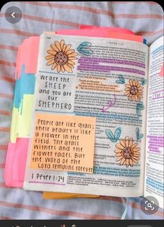 an open bible with colorful sticky notes attached to the pages and some writing on it