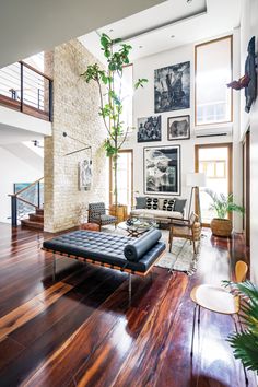 a living room filled with furniture and pictures on the wall above it's fireplace