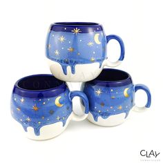 three blue and white mugs with stars on them